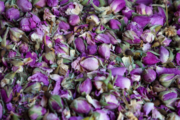 Pile of dried rose flowers used as natural fragrances displayed on souk - traditional street market in Morocco