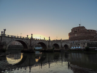 Fototapeta premium Beautiful view of Ponte Sant'Angelo (Sant'Angelo Bridge) reflected on the waters of the Tiber River and of Castel Sant'Angelo - Rome, Italy