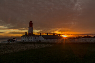 The red and white striped, 23 meter tall,  Souter Lighthouse and the Leas in Marsden, South Shields, England, as the sun rises