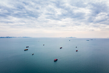 aerial seascape view and small container ship floating in sea horizon and cloud sky background  in