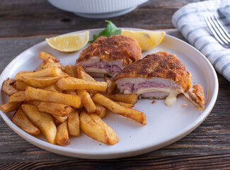 Cordon Bleu made with chicken breast and filled with ham and cheese. Served with french fries