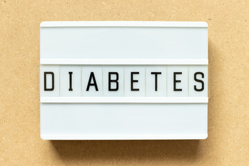 Lightbox with word diabetes on wood background