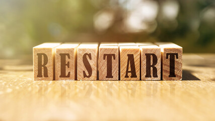 Wooden Blocks with the text: Restart in black letters