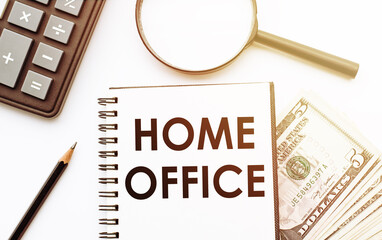 HOME OFFICE text on notepad with calculator, magnifier, money and pencil on the office desk