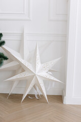 two pointed cardboard Christmas stars on a white background. The concept of the new year.