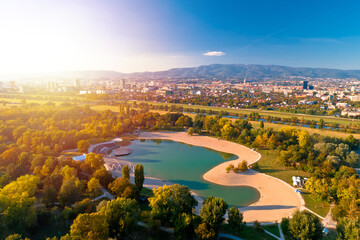 Bundek lake and city of Zagreb aerial autumn sun haze view