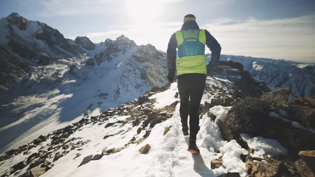 Man running at the mountain with snow