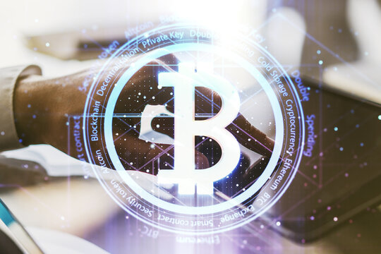 Creative Bitcoin concept with finger clicks on a digital tablet on background. Multiexposure