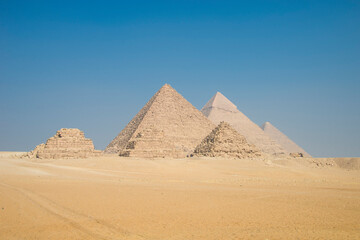 Fototapeta na wymiar Landscape of the pyramids in the desert with blue sky in Giza, Egypt