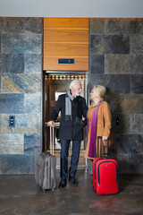 An older couple standing together in the hotel lobby for theirs Valentines holiday