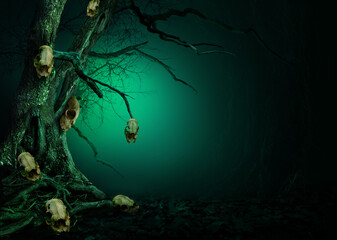 Old tree with skulls hanging on crooked branches. Mystical landscape with blue light on dark background