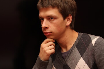 Young man in sweater on black background