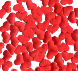 Valentine's Day background. scattering of red silk hearts on a white background