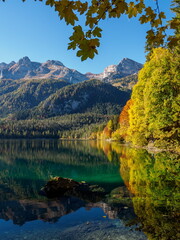 Fototapeta premium Autumn foliage reflections in the cristal clear waters of Tovel lake, Dolomites, Italy