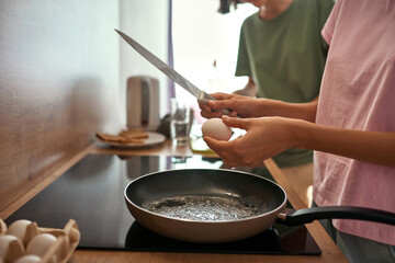 Partial of girls cooking breakfast at home kitchen