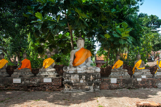 Aligned Sitting Buddha Statues at Wat Yai Chaimongkol in Ayutthaya, the 13 century historic capital of Kingdom of Siam, Thailand