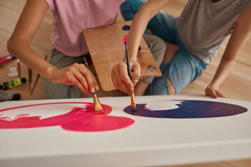 Cropped image of women painting picture at home