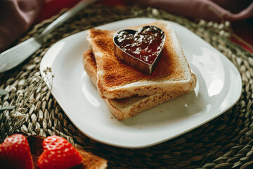 Toast with jam in the shape of a heart.
Conceptual Valentine's day, love, romanticism
