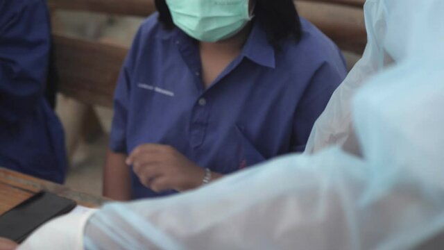 Slow motion scene of Asian students check ATK 