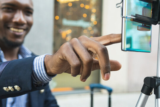 Black man live streaming on street