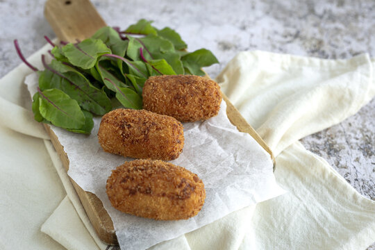 Fried croquettes served with greens