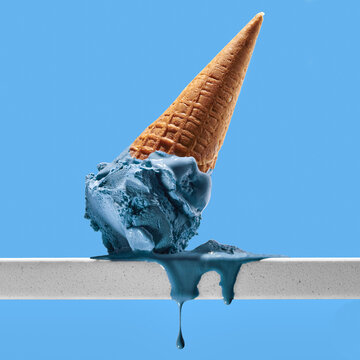 Delicious gelato on metal railing against blue background