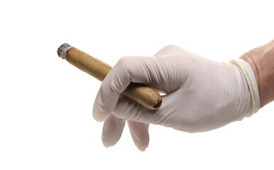 Luxury handmade cigar glowing ember in latex surgical glove hand isolated on white  