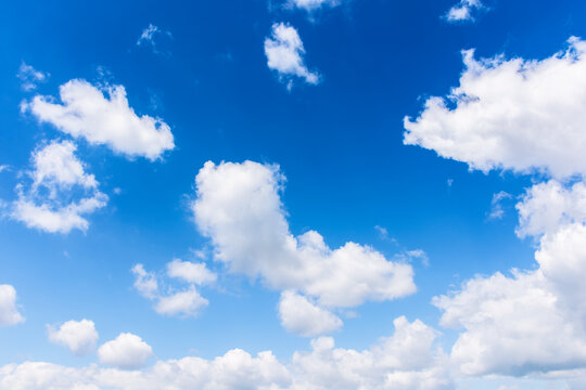 white fluffy clouds on the azure sky. calm weather in spring. beautiful nature background