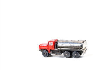 Truck with a tank - a children's toy on a white background. Fuel truck car. Truck with a tank for transporting liquid. Motor vehicle. Freight transport business. White background. Free space for text.