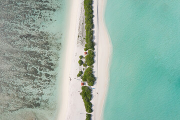 Aerial view of a tropical island with a white sand beach and turquoise waters. Dhigurah island, Maldives.