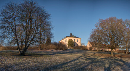 Old profane castle building from 1650s, Hässelby slott in its park a sunny frosty winter day in Stockholm