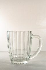 Beer glass, on a light substrate, with a light background. Beer mug, on a light background.