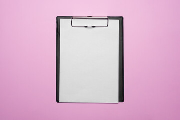 Blank paper page with copy space on the pink flat lay background. Order template. To do list or a plan mockup.