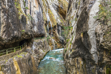 Famous hiking trail between mountains bordering the Cares river in Asturias Spain