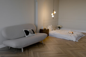 Sofa and mattress for sleeping in the room Lamp and candles in the bedroom Minimalist style