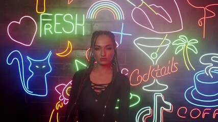 Hot dancer girl with perfect shapes dressed in black 4K. Enjoying dancing movements in the club. Red Neon background UHD