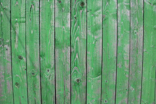 Old weathered Boards on Painted green wooden Fence Wall with Vertical background texture