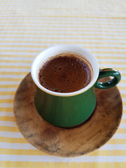 Turkish coffee foam close-up in the green cup. cup of coffee