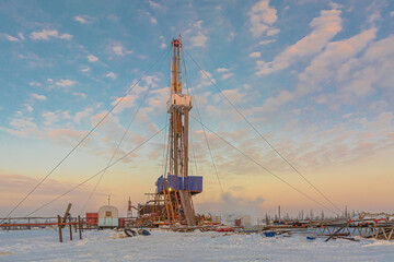 Drilling wells in the winter at an oil and gas field in the Arctic. Polar day with textured...