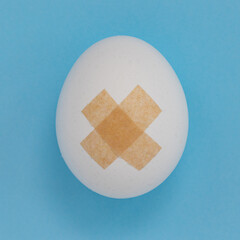 adhesive bandage on blue background close up