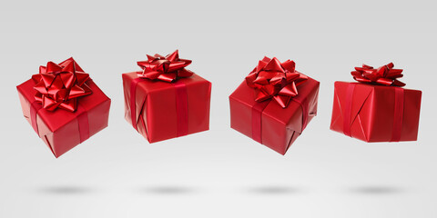 Beautifully wrapped gift boxes flying on light background