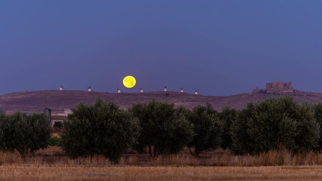 Full Moonset behind Consuegra iconic windmills