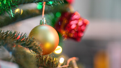 Close up of balls on Christmas tree. Bokeh garlands in the background. New Year concept.