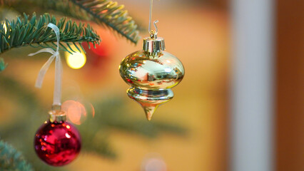 Close up of balls on Christmas tree. Bokeh garlands in the background. New Year concept.