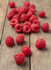 A group of raspberries over wooden table