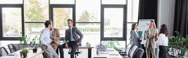 young multiethnic business people talking during coffee break in modern office, banner.