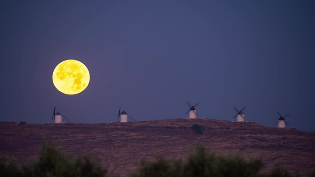 Full Moonset behind Consuegra iconic windmills