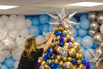 The figure of a Christmas tree made of balloons. The symbol of the new 2022