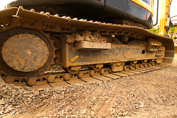 Excavator on caterpillars,heavy construction equipment consisting of a boom, dipper, bucket and cab on a rotating platform known as the house.The house sits atop an undercarriage with tracks or wheels
