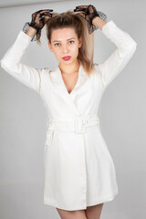 Naklejka premium Woman with long hair and white skin isolated on grey straightening ponytail